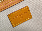 Beige canvas label with “LOUIS VUITTON PARIS” text on orange leather patch.