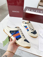 Gucci sneakers with cream leather, navy GG canvas, and multicolor stripe side
