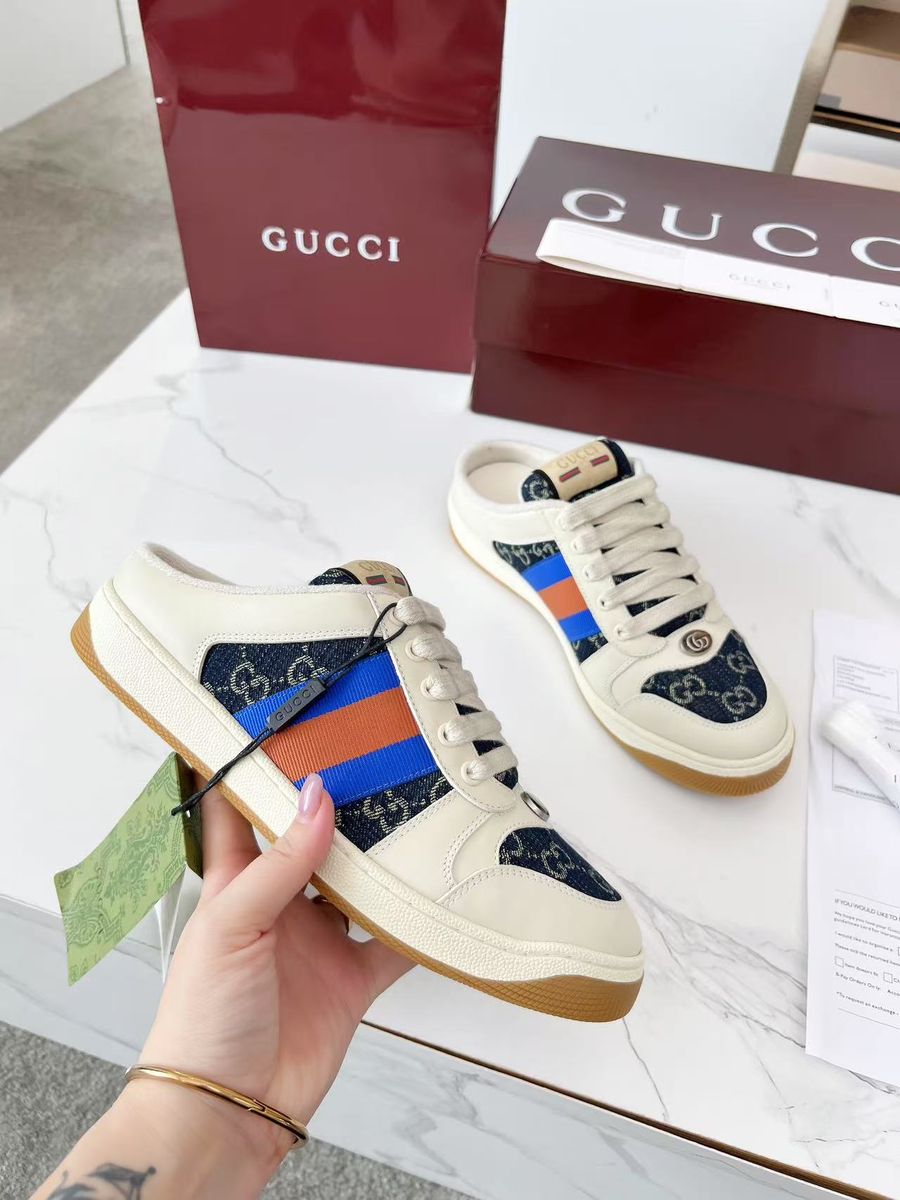 Gucci sneakers with cream leather, navy GG canvas, and multicolor stripe side