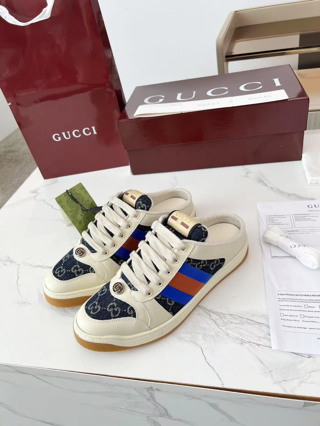 Gucci low-top sneakers, cream upper with navy GG canvas and blue-red stripe panels