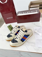 Gucci low-top sneakers, cream upper with navy GG canvas and blue-red stripe panels