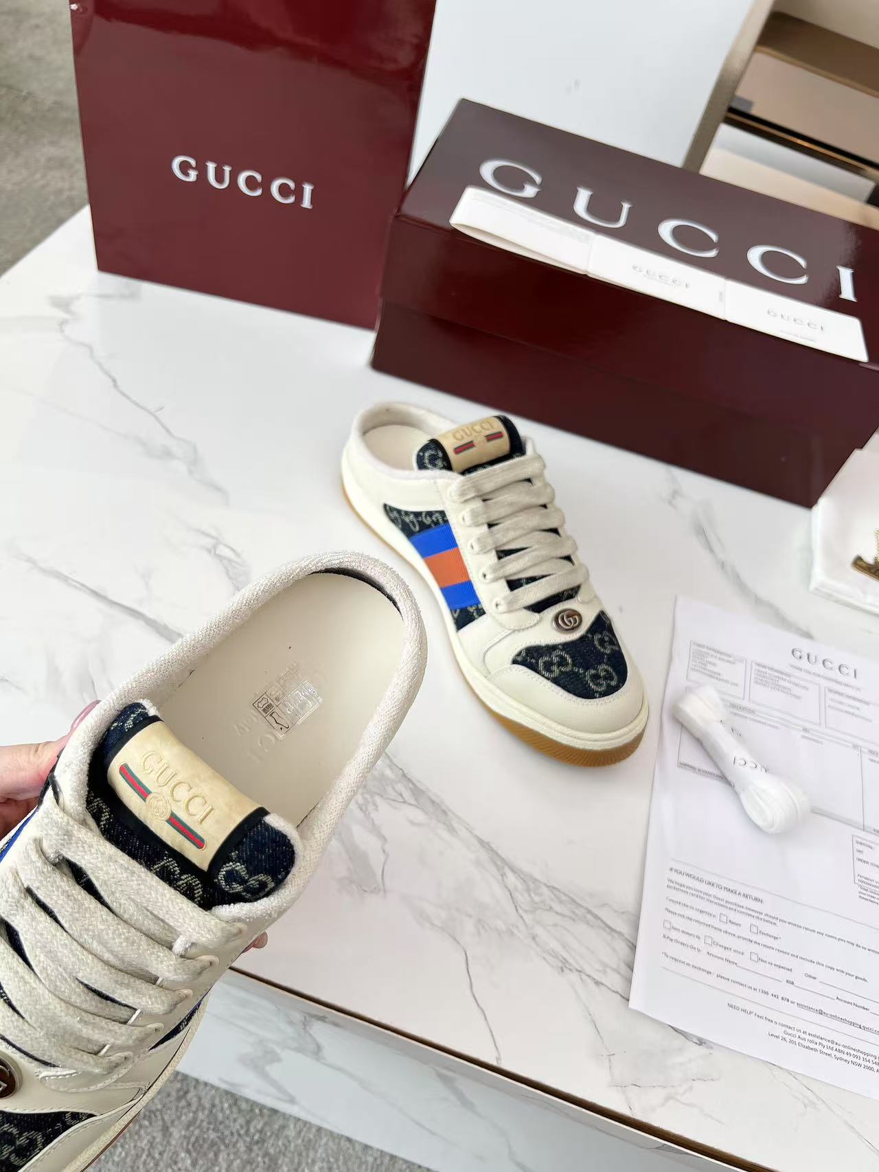 Gucci low-top sneakers, cream upper with navy GG canvas and multicolor stripe detail