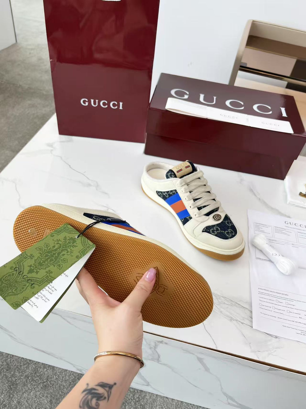 Gucci sneaker outsole view, tan rubber sole with cream and navy upper edge