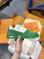 Green-and-white Louis Vuitton trainer with LV logo patch and white laces