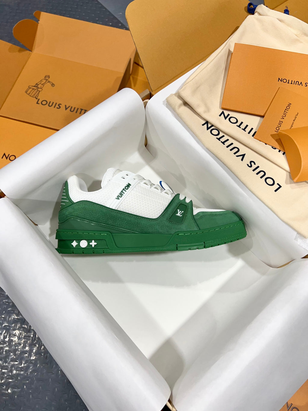 Green-and-white Louis Vuitton trainer single showing side LV logo and white laces