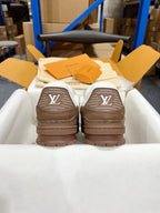Louis Vuitton trainer sneakers, rear view with brown soles and LV logo at heel