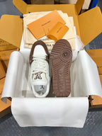 Louis Vuitton trainer sneakers showing outsole tread with white uppers and brown base