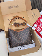 Coah monogram shoulder bag with tan leather trim and gold-tone hardware