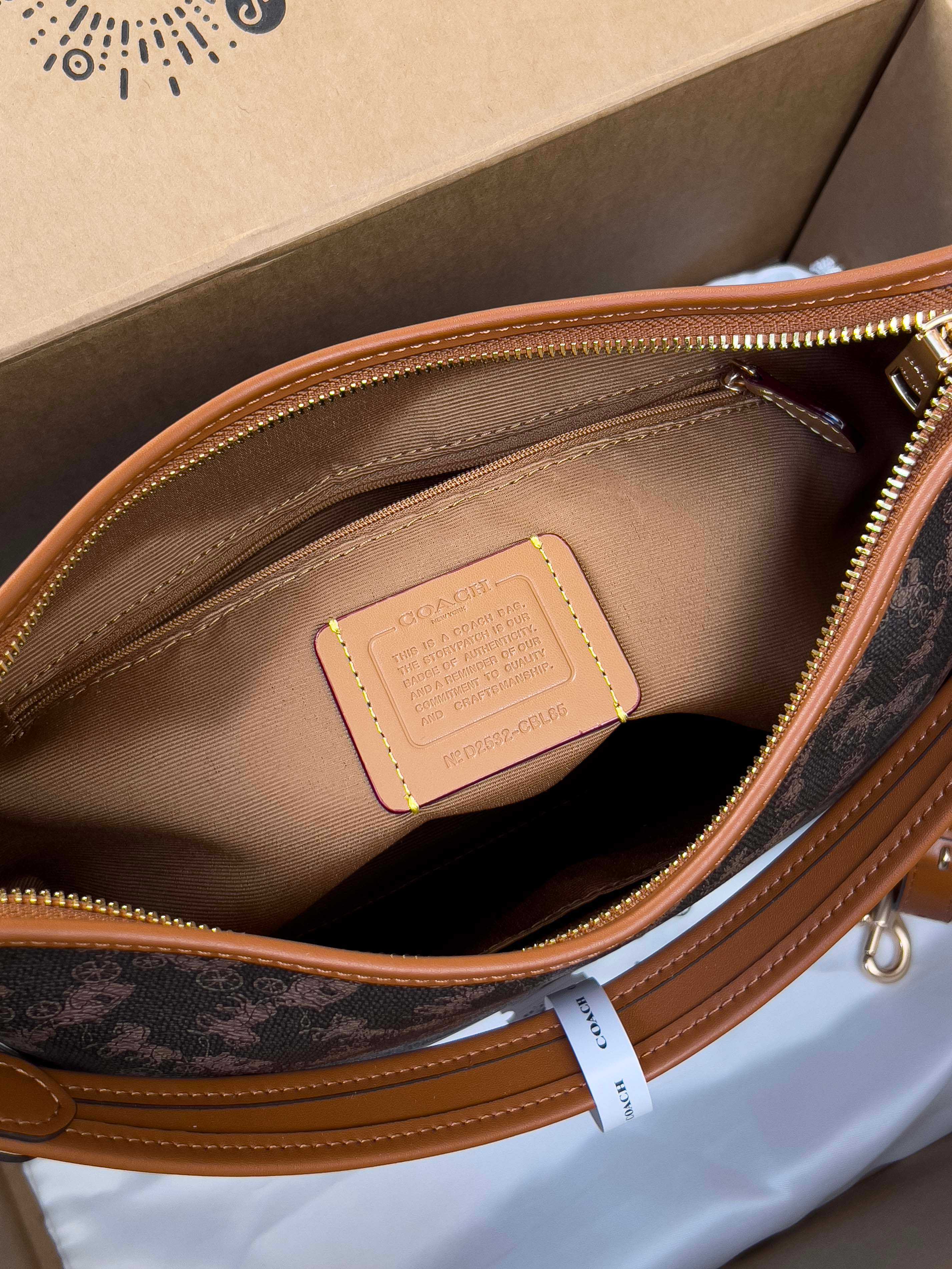 Coah monogram bag interior with brown lining and zippered pocket detail