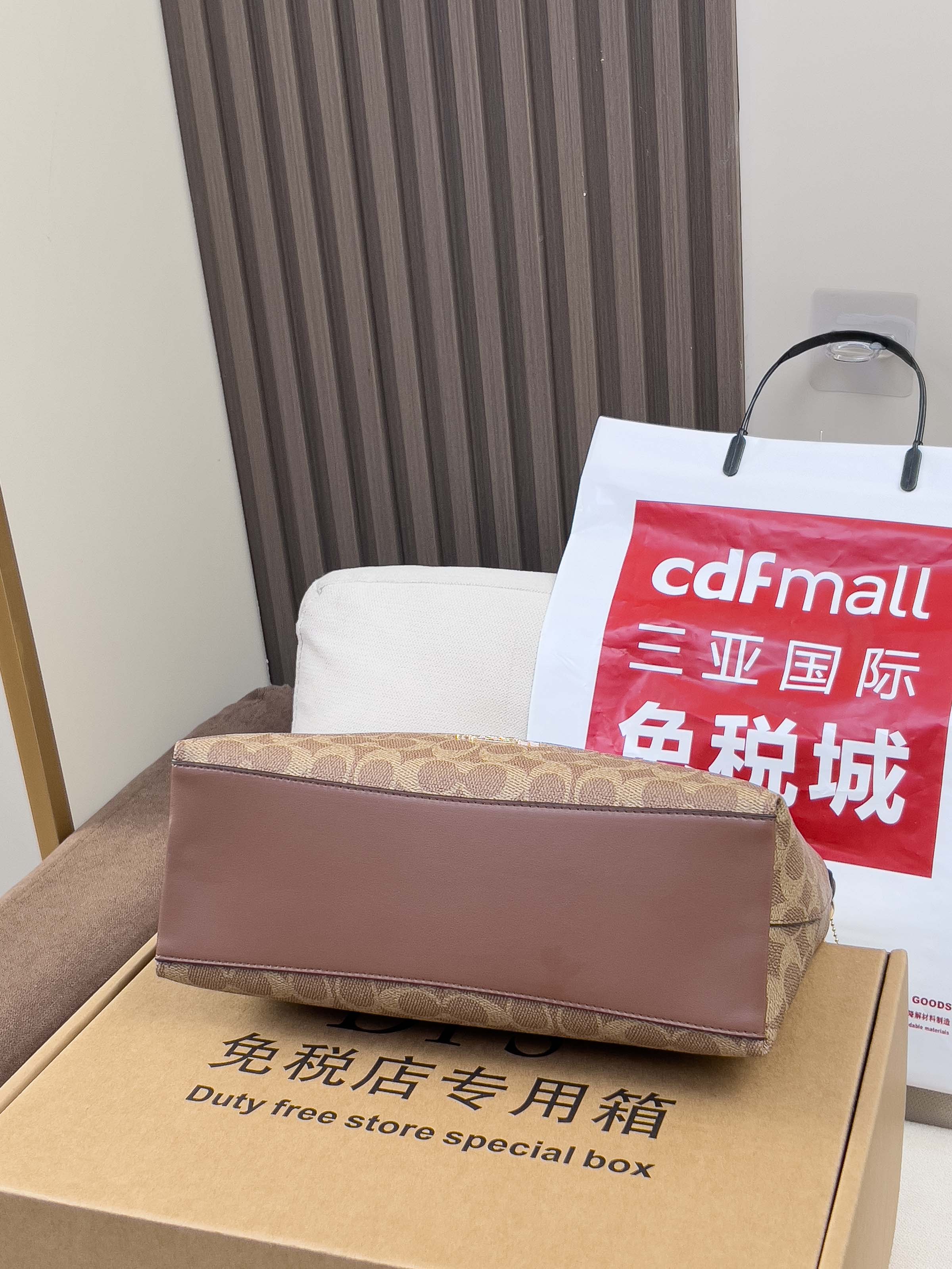 Duty-free store special box and shopping bag with red logo on cushion