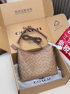 Brown monogram shoulder bag with gold-tone hardware and top zip opening