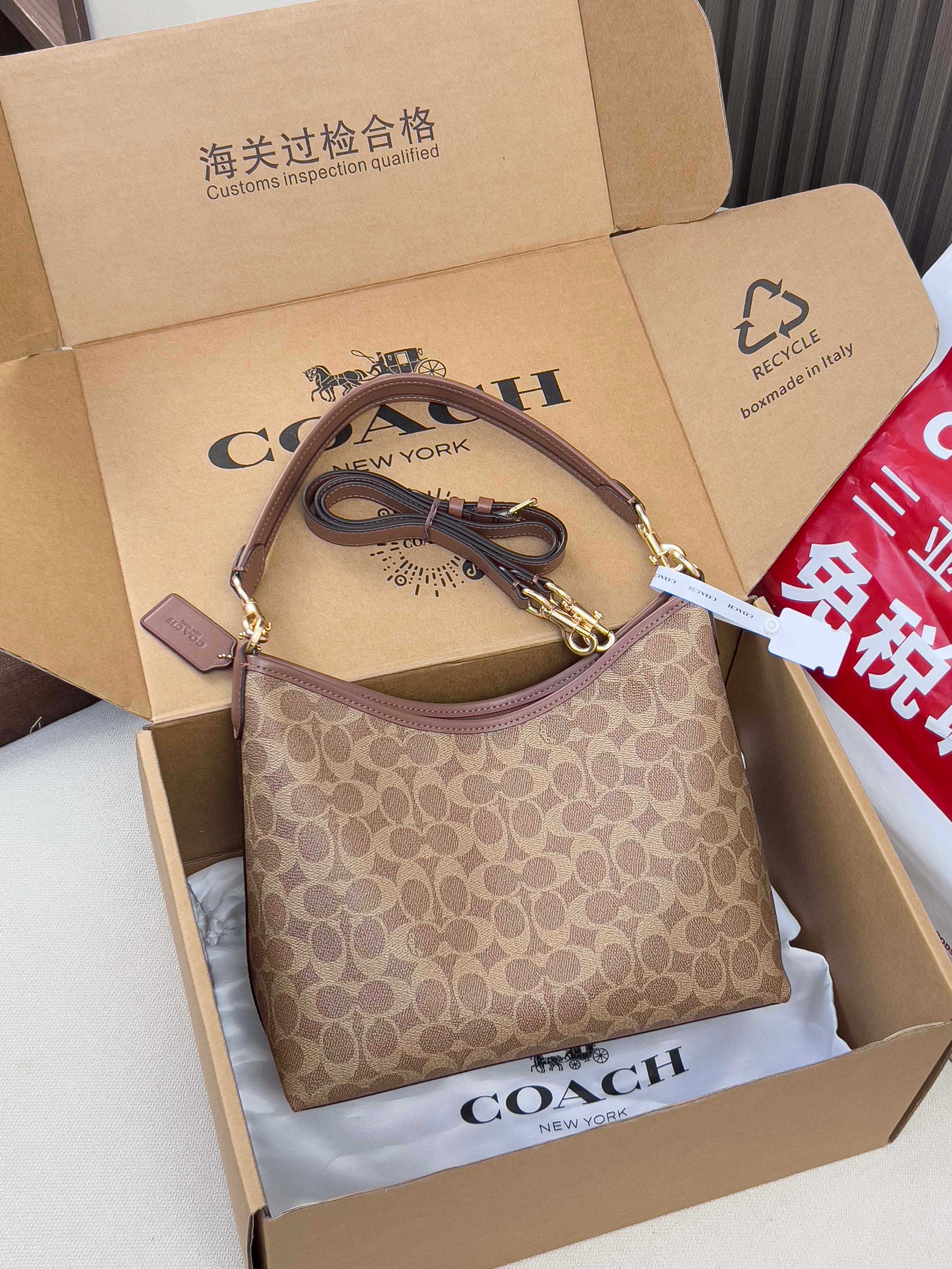 Brown monogram shoulder bag with gold-tone hardware and top zip opening