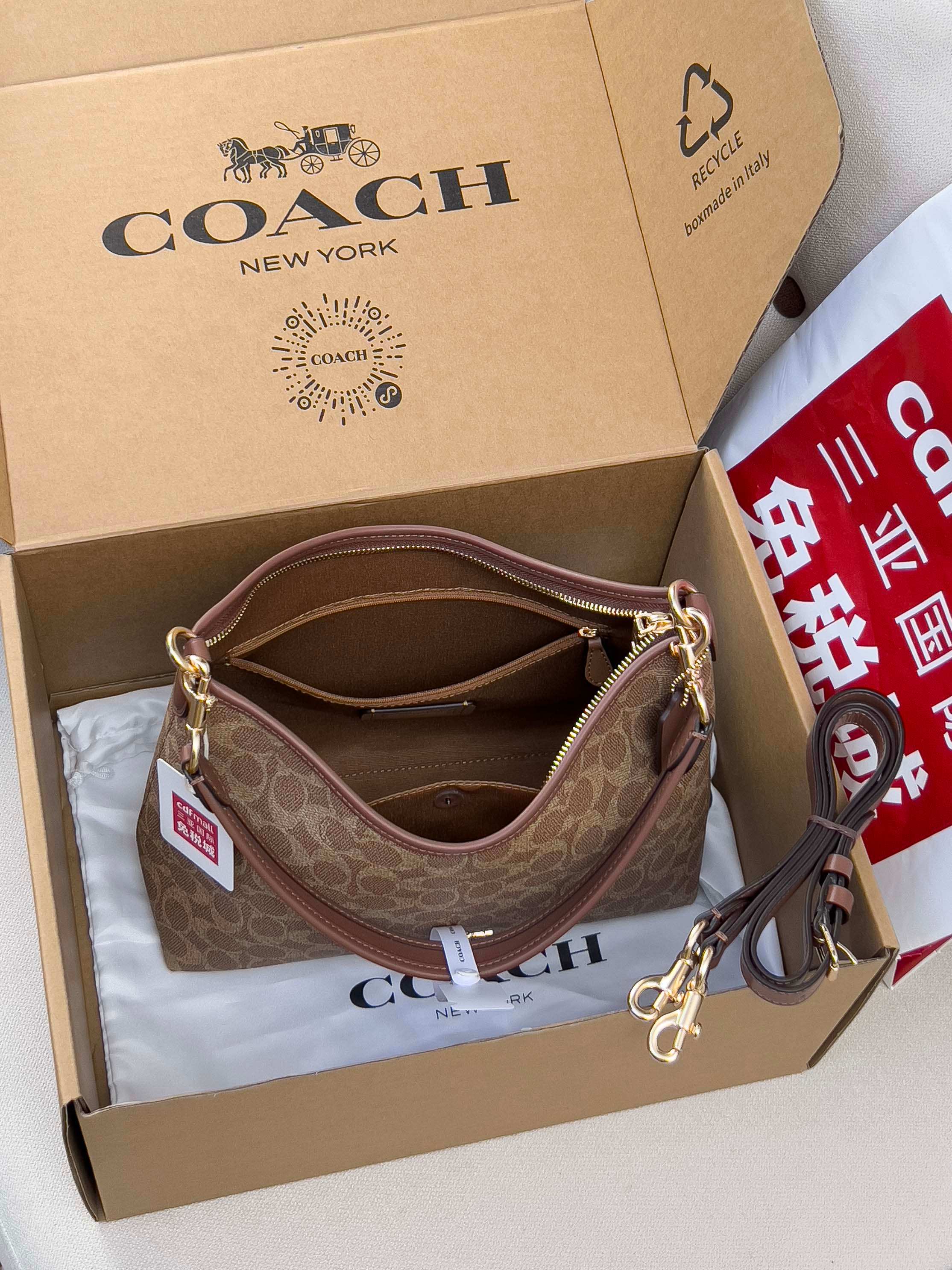 Brown monogram hobo bag with top zip, chain strap, and gold-tone hardware