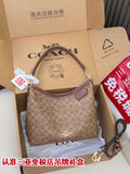 Brown monogram crossbody bag with top zip and adjustable shoulder strap