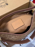 Brown monogram handbag interior with rectangular leather brand patch