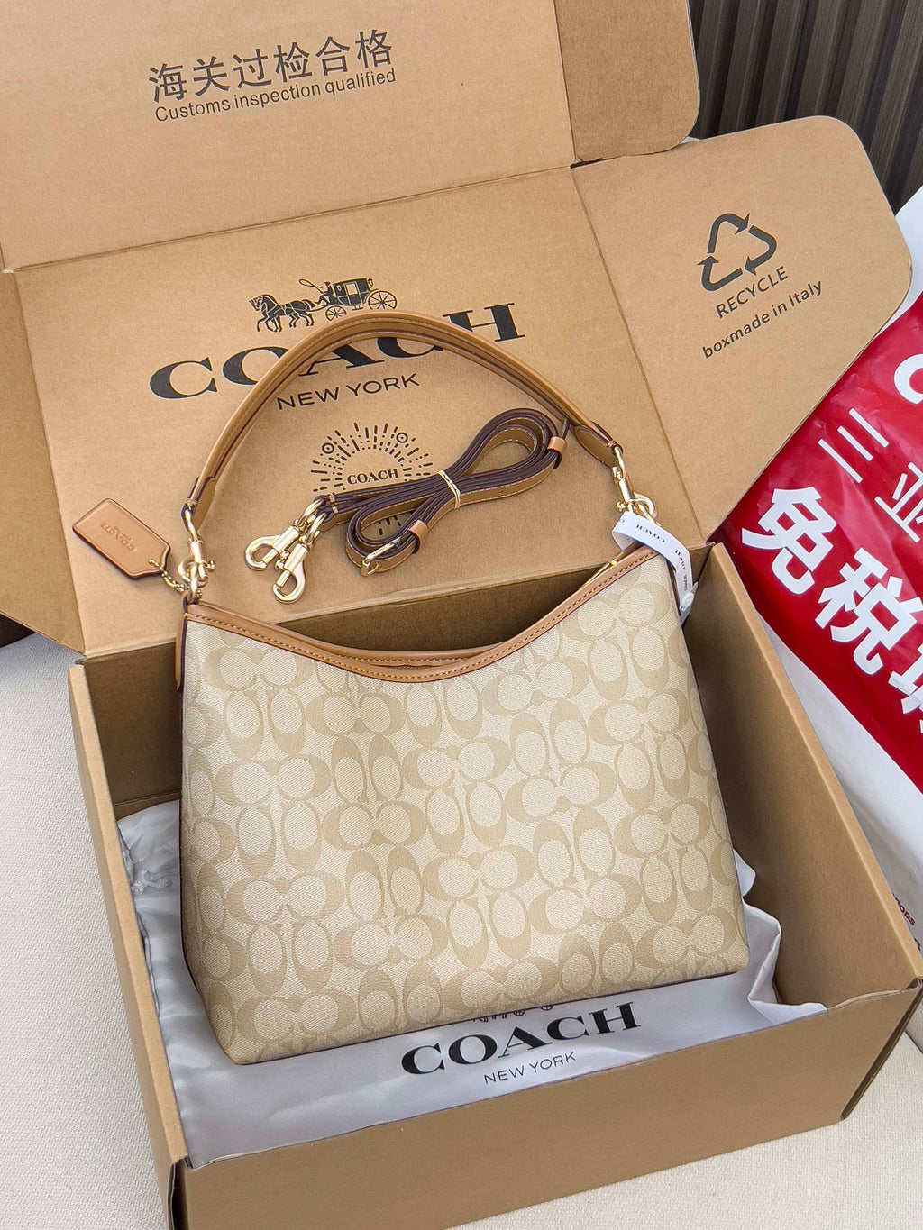 Coach signature mini shoulder bag, light tan monogram, top zip and tan leather strap.