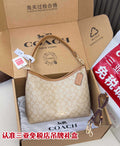 Coach signature hobo bag, light tan with monogram pattern, zip top and leather strap.