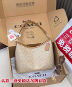 Coach signature hobo bag, light tan with monogram pattern, zip top and leather strap.