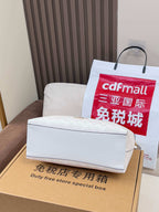 Coah handbag storage box set, white mailer with red shopping bag inside
