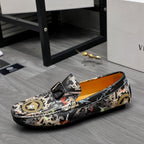 Patterned slip-on loafers in black with gold-and-floral print; low profile sole