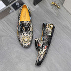 Patterned slip-on loafers with black upper, ornate trim, and orange interior lining