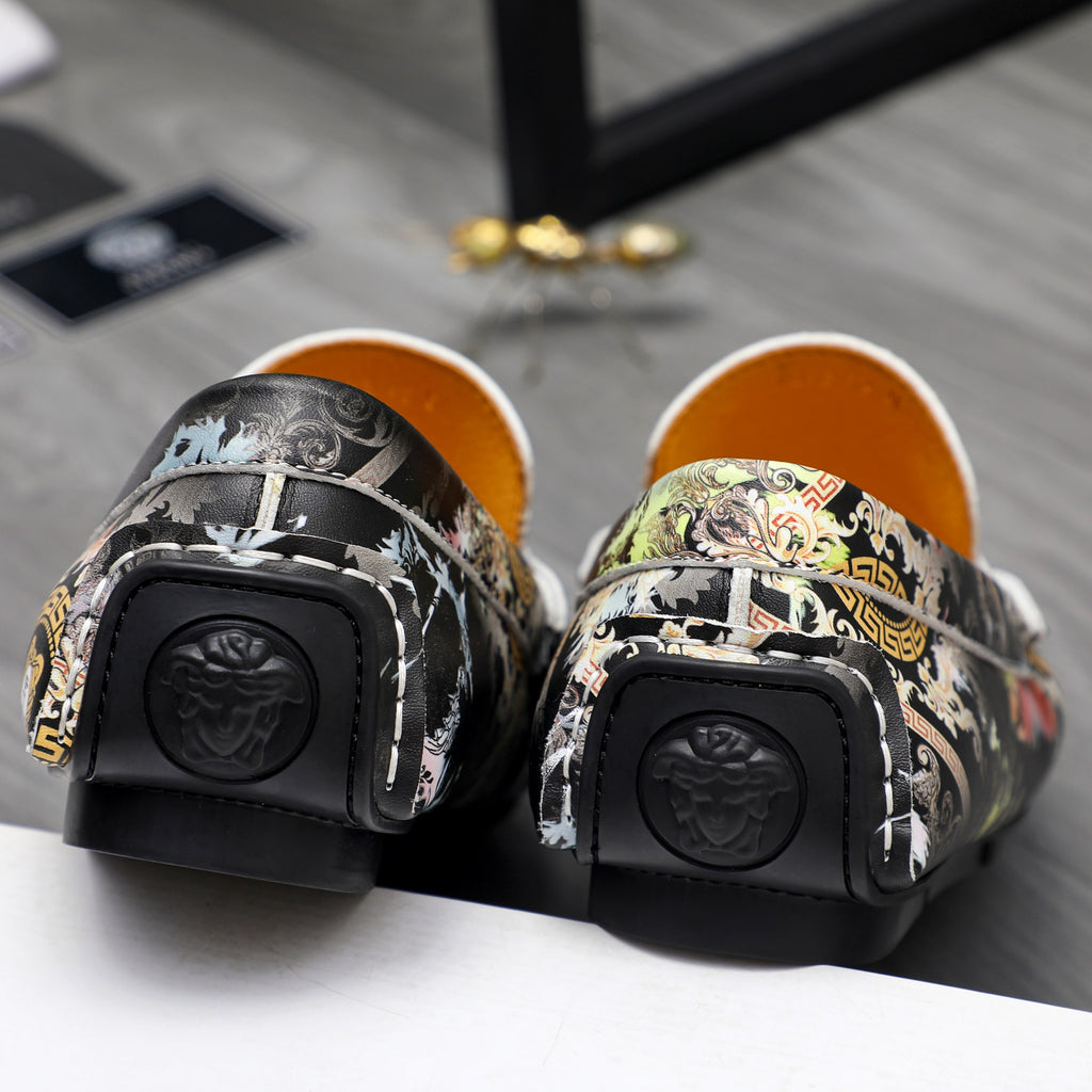 Back view of patterned slip-on loafers with black heel protectors and textured soles