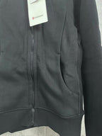 Dark hoodie zipper placket with curved pocket seam detail