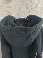Dark hoodie hood lining with small circular logo patch