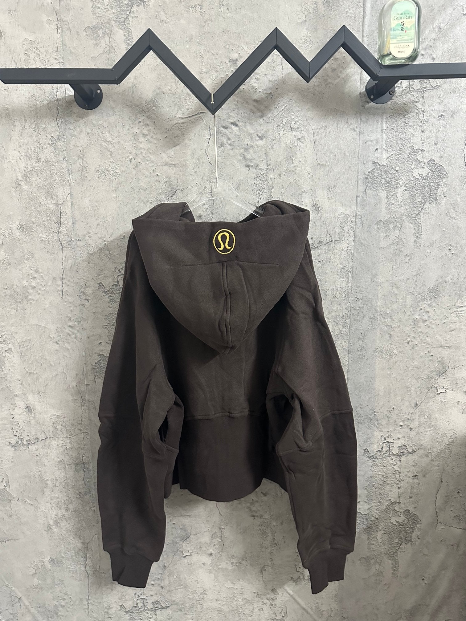 Dark zip-up hoodie with hood and front pouch pockets