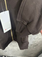 Dark zip-up hoodie with ribbed hem and hood drawstring