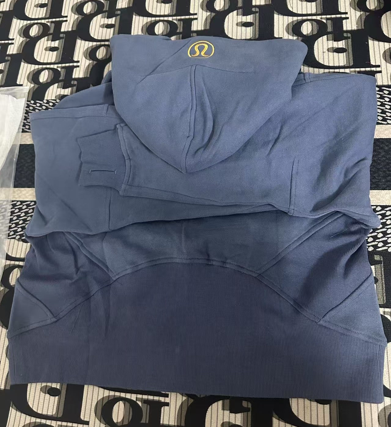 Ralph Lauren blue hoodie folded on patterned fabric