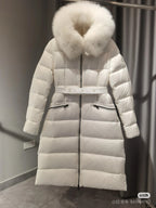 Long white puffer coat with faux fur hood and waist belt, quilted panels