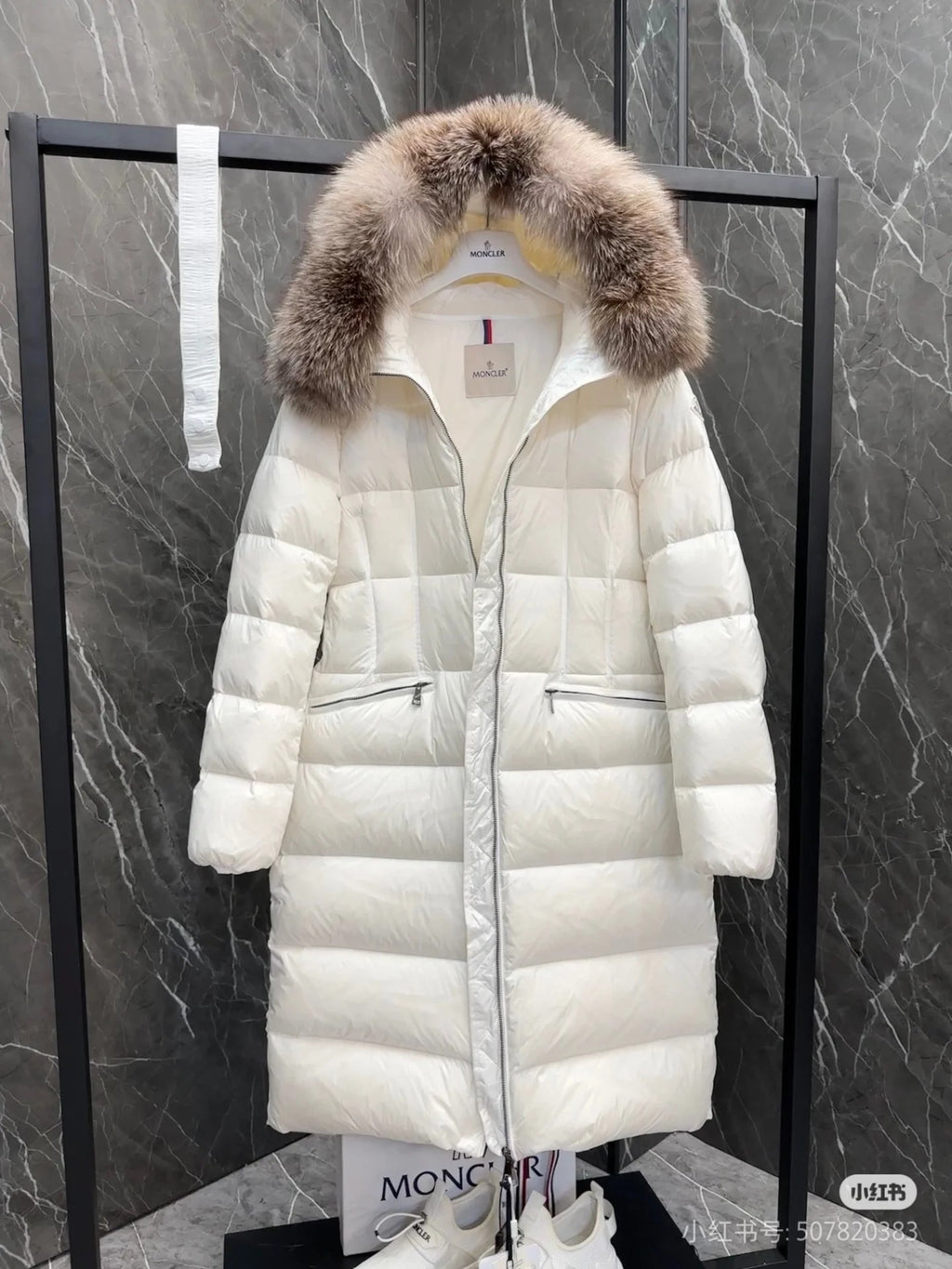 Long white puffer coat with faux fur hood, front zipper, flap pockets