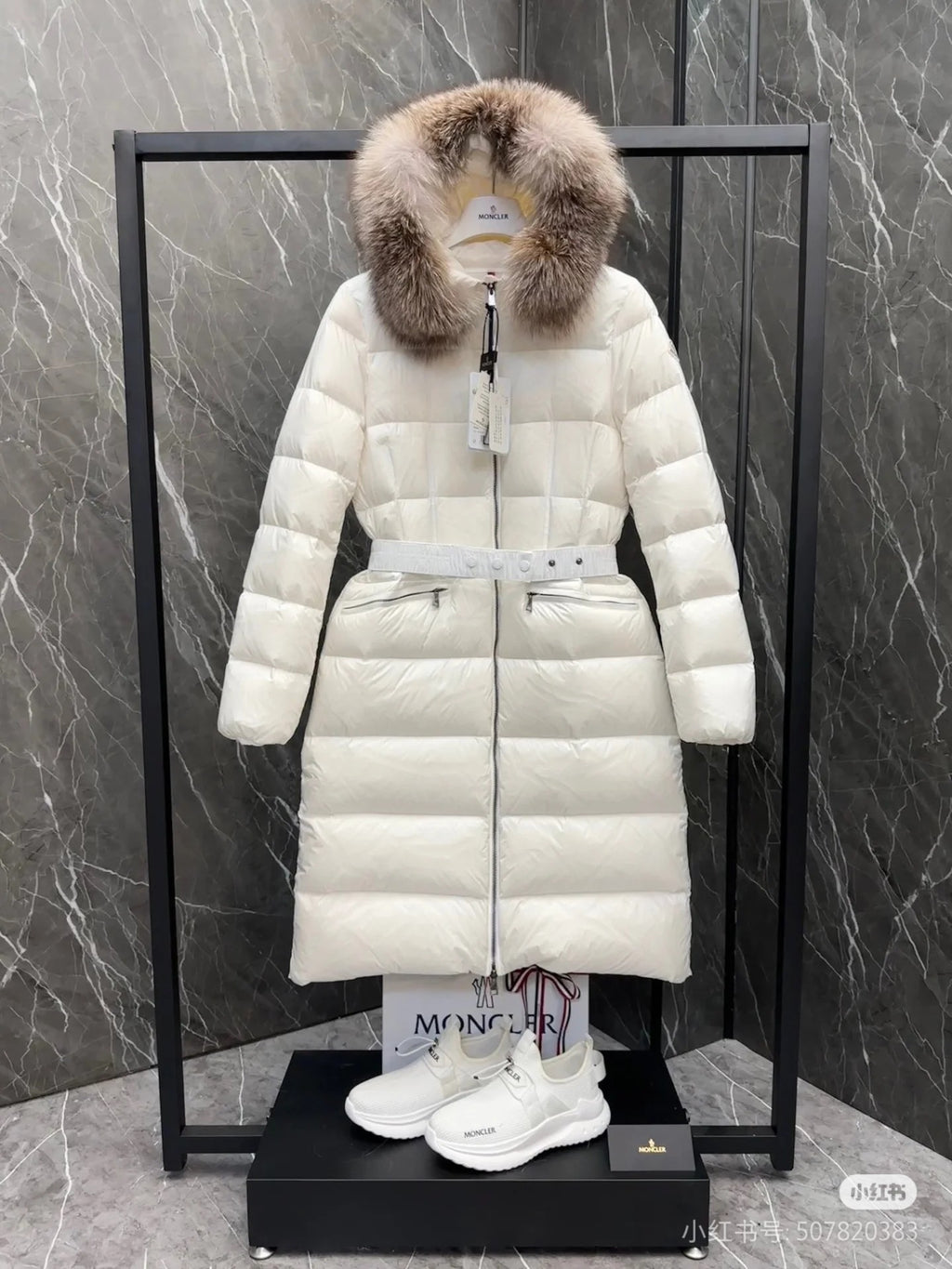 Long white puffer coat with faux fur hood, front zipper, belted waist