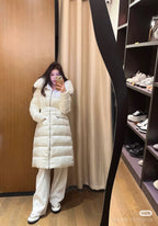Long white puffer coat with faux fur hood, belted waist, front zipper
