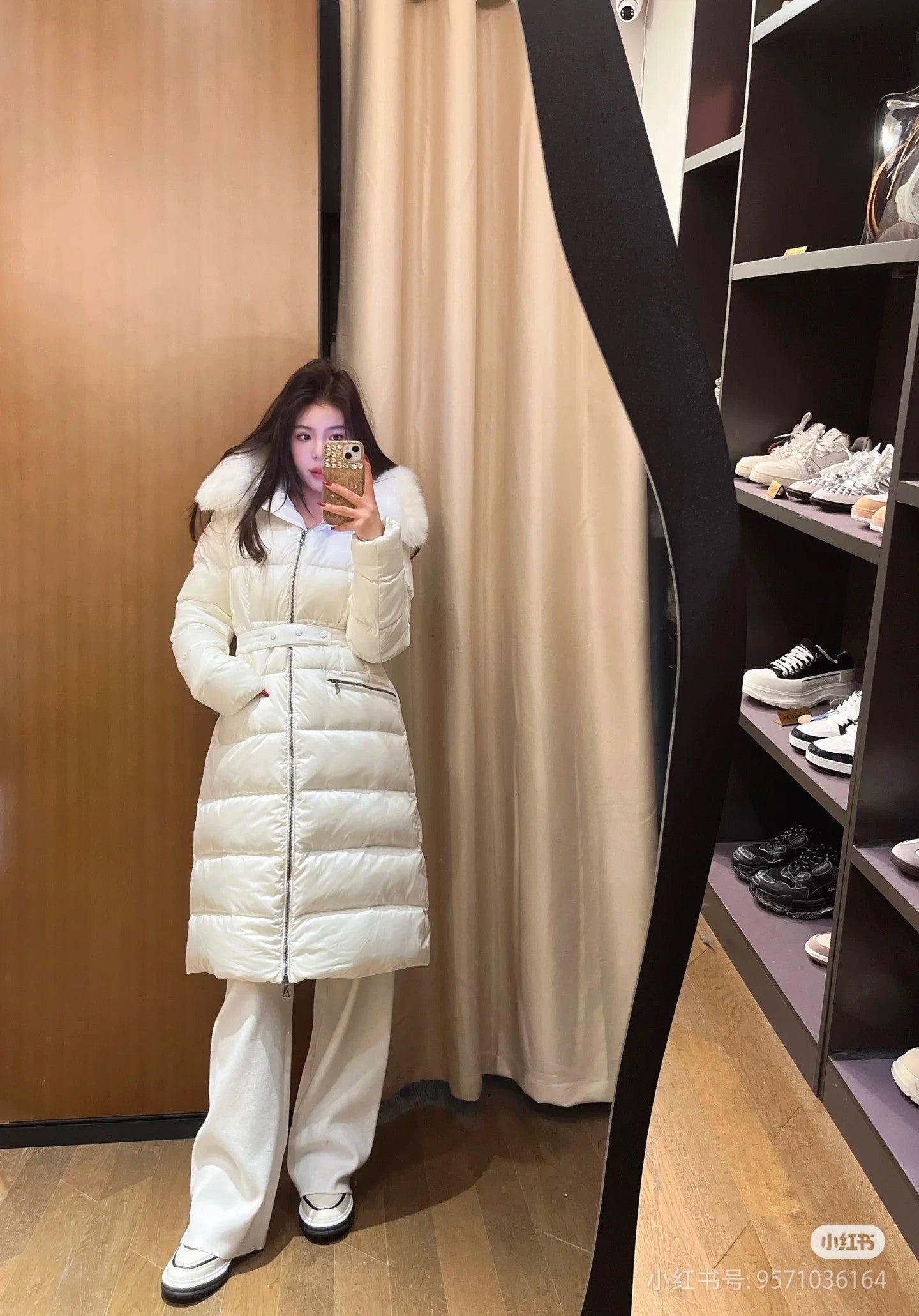 Long white puffer coat with faux fur hood, belted waist, front zipper