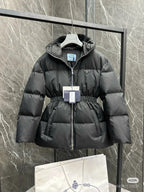 Black hooded puffer jacket with front zipper and cinched waist detail