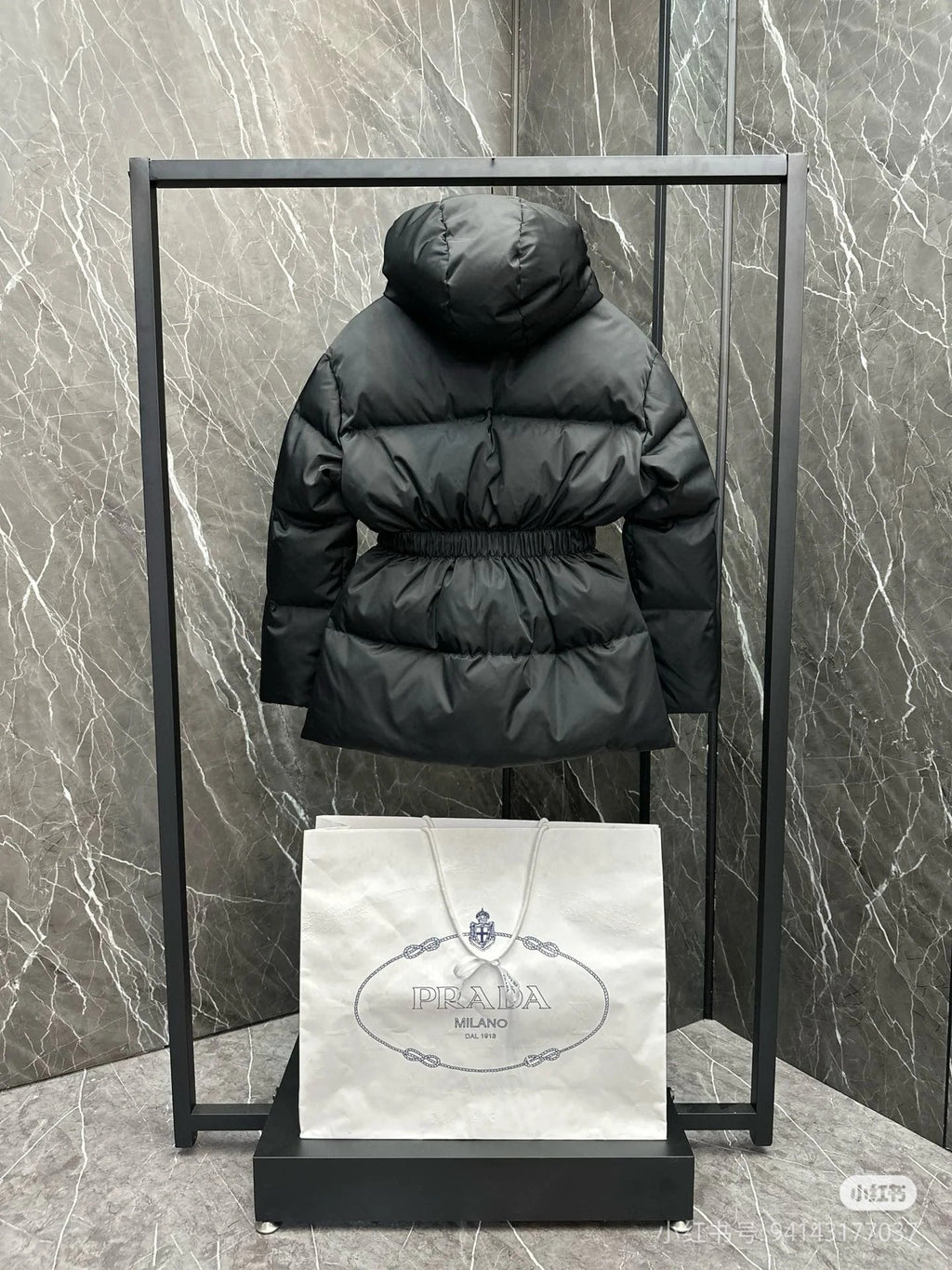 Black hooded puffer jacket with full zip, back view, elastic waist
