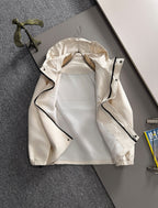 Off-white hooded jacket with open front and black zipper pulls