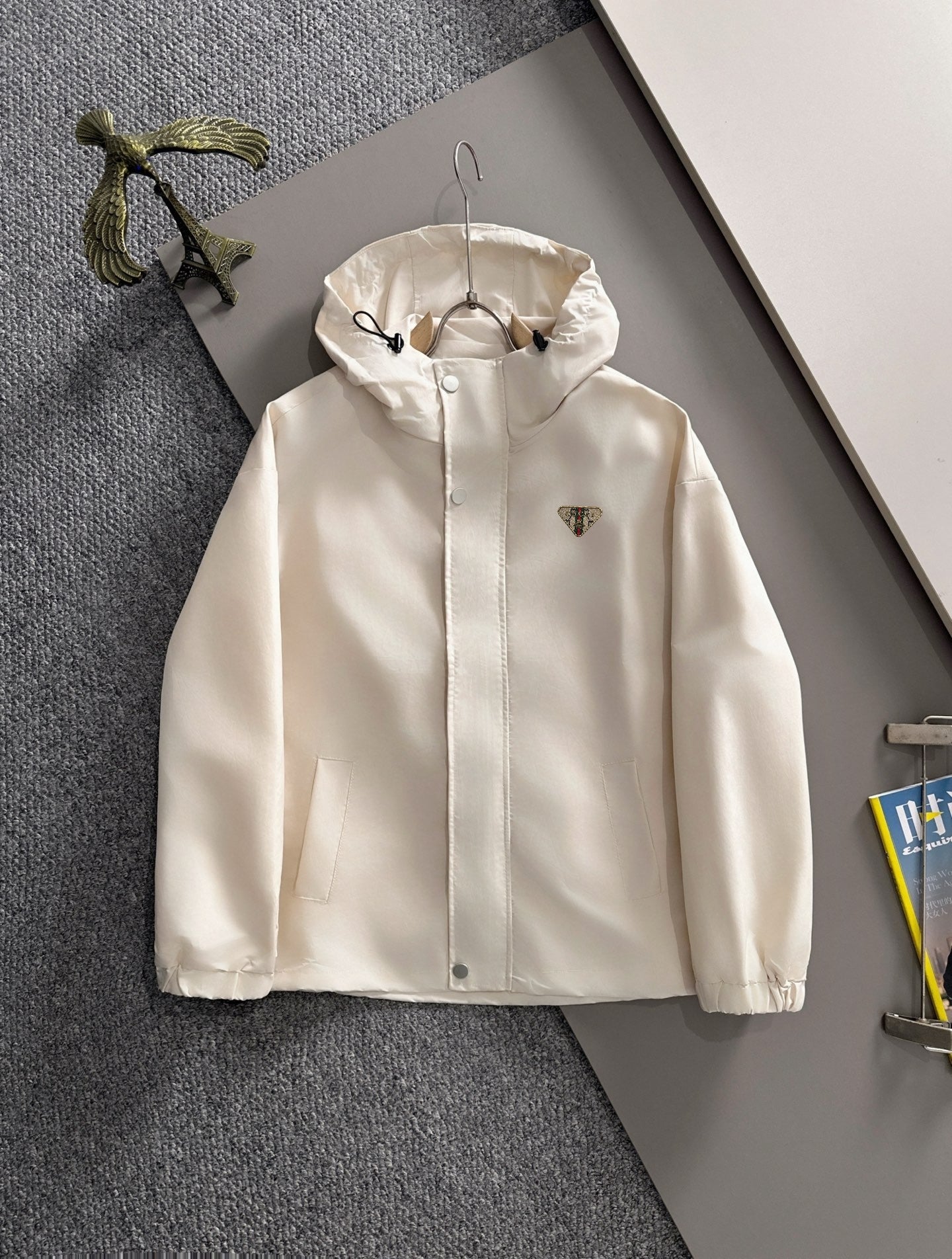 Off-white hooded long jacket with front zipper and drawstring hem