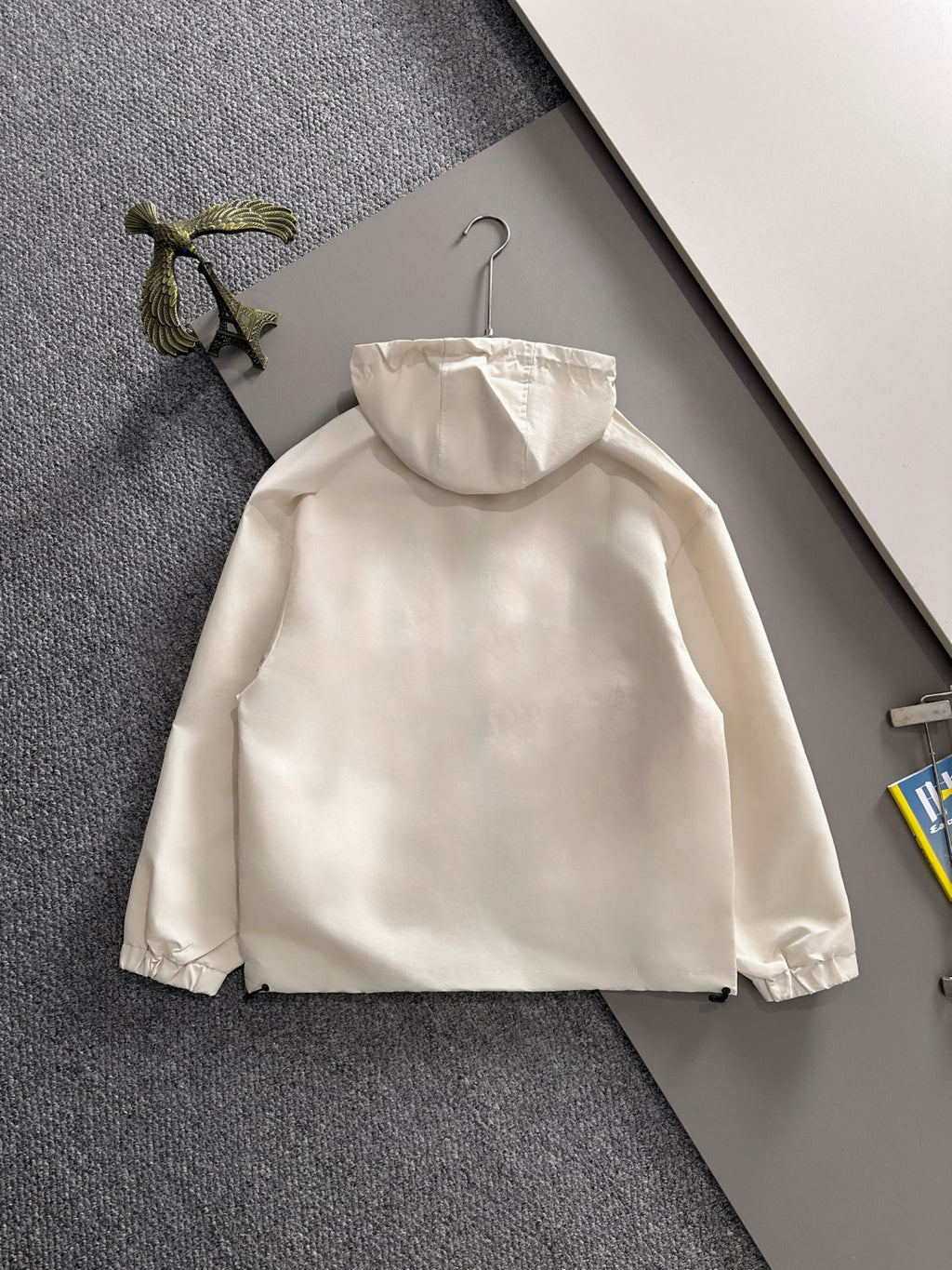 Off-white hooded long jacket with zipper front and relaxed silhouette