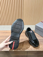 Black lace-up sneaker outsole view with textured rubber tread pattern