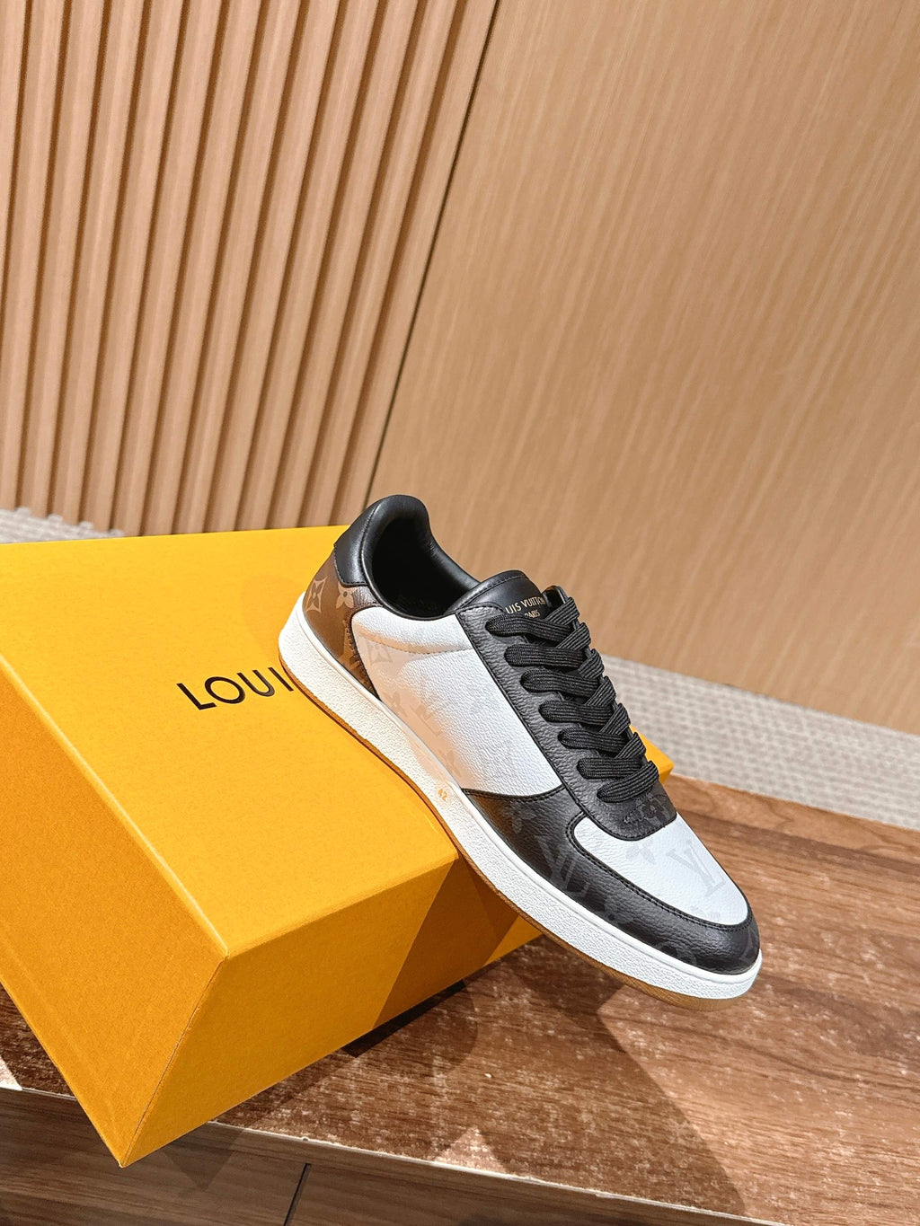 Low-top Louis Vuitton sneakers, black and white with monogram panels, lace-up