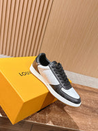 Low-top Louis Vuitton sneakers, black and white with monogram panels, lace-up