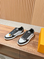 Pair of low-top Louis Vuitton sneakers in black and light gray, lace-up with white sole