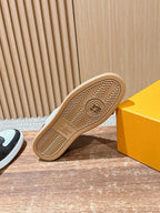 Louis Vuitton sneaker outsole viewed from below, tan rubber tread with logo
