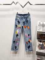Light blue Chrome pants with colorful patch graphics and black cross motifs on legs