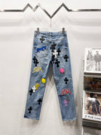 Light blue Chrome pants with patch graphics, black cross motifs, and a pink flamingo patch
