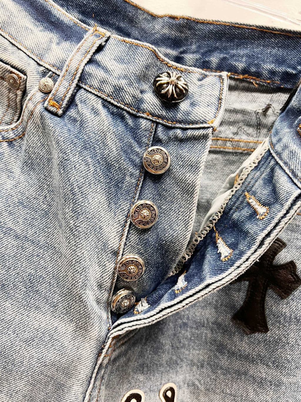 Light blue denim Chrome pants with button fly and small star patch detail on pocket