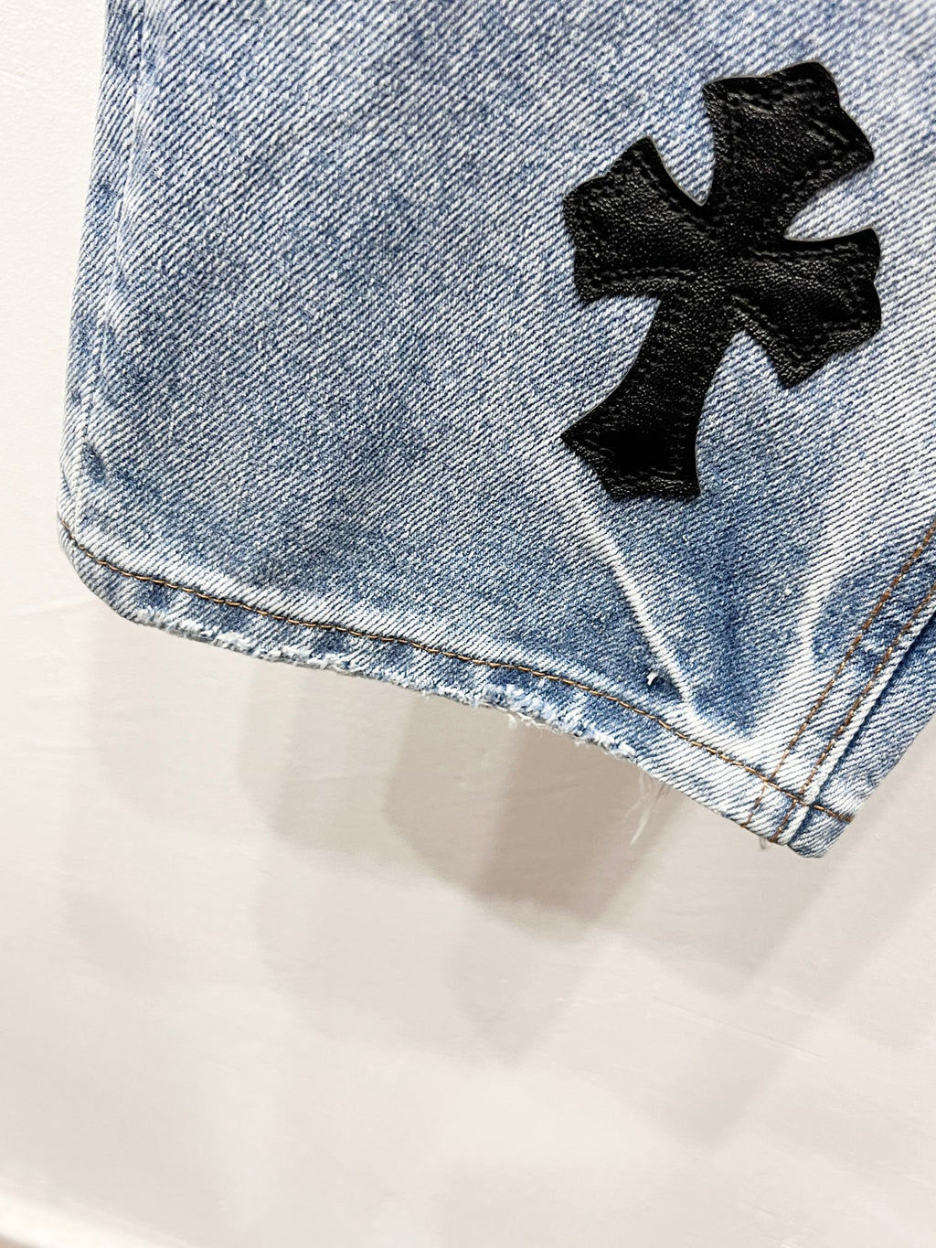Light blue Chrome pants with a black cross patch near the leg hem